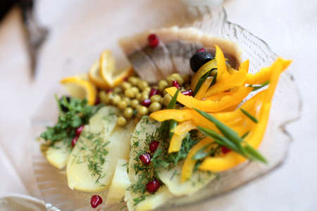 Vegetables and salted herring as cold collationの写真素材