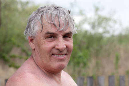Portrait of smiling gray haired man outdoorの写真素材