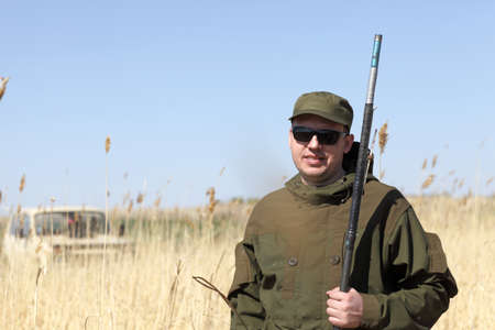 Portrait of fisherman on a field in spring