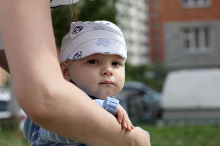 Portrait of serious child with summer cap outdoorの写真素材