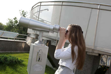 The teen is looking through binoculars, Moscowの写真素材