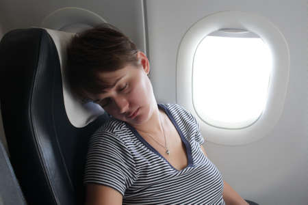 The woman is sleeping at the airplaneの写真素材