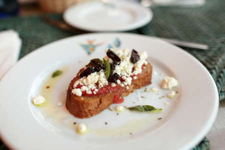 Riganatha is grilled bread with feta and tomatoesの写真素材