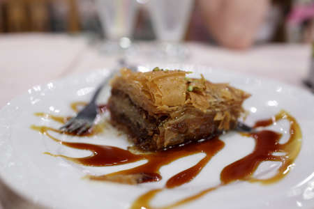 Baklava with syrup on a white plate in a greek restaurantの写真素材