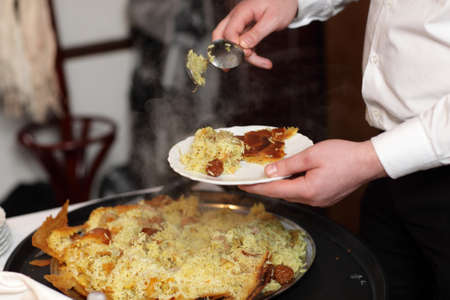 Chef is putting pilaf on a plate at an azerbaijani restaurantの写真素材