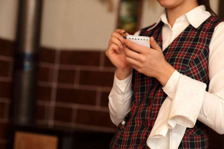 The waitress getting order at a restaurantの写真素材