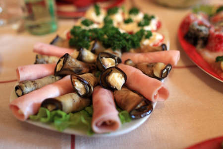 Ham and eggplant with garlic cheese on a plateの写真素材