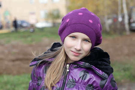 The young girl is posing in the parkの写真素材
