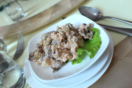 Salad on a white plate in a restaurantの写真素材