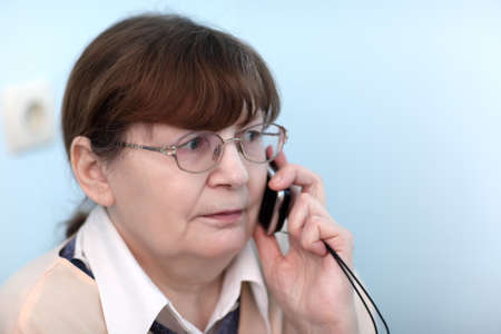 Portrait of serious woman with mobile phoneの写真素材