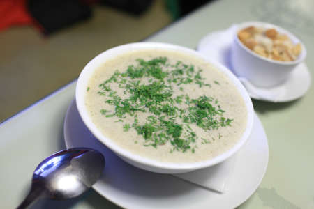 Cream of mushroom soup on a plate in a french restaurantの写真素材