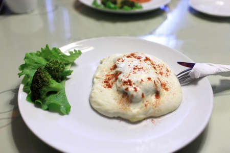 Steak with cream sauce on a white plateの写真素材