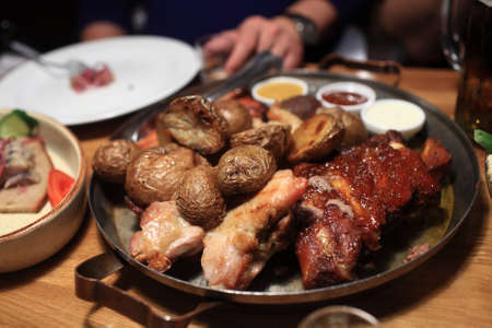 Various roasted meat with potatoes in a pubの写真素材