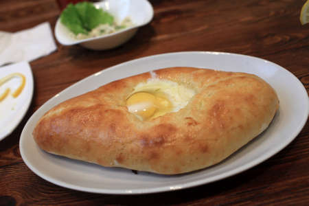 Adjarian Khachapuri with egg in a georgian restaurant