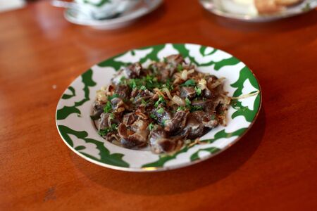 Stewed giblets on the plate in a restaurantの写真素材