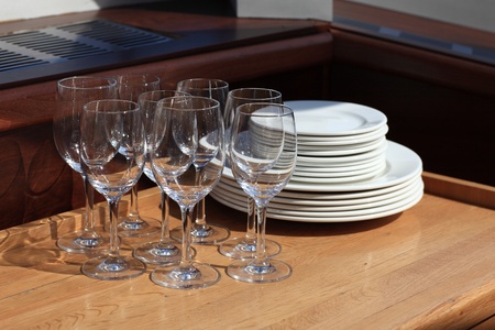 Wine glasses and plates on a wooden table