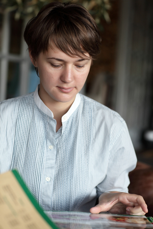The woman is choosing dish at cafeの写真素材