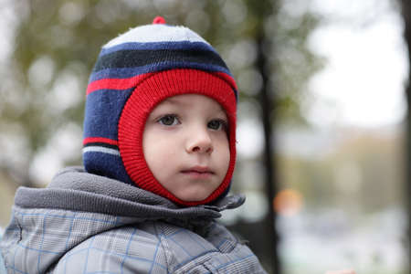 Portrait of pensive child at autumn park