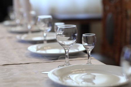 Glasses on a table set for a banquet in a restaurantの写真素材