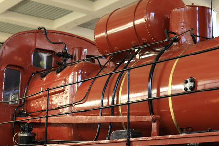 Details of old red locomotive in a museum