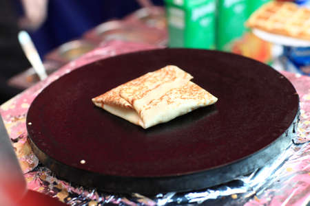 The rolled pancake on a hot burnerの写真素材