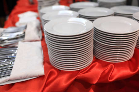 Tableware on a red tablecloth at the banquet