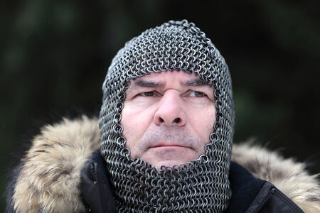 Mature man posing in armor outdoor in winterの写真素材