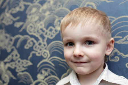 Portrait of smiling child on the wall backgroundの写真素材