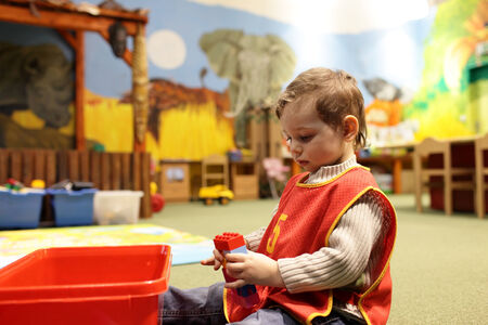 Child playing with construction toys at a kindergarten