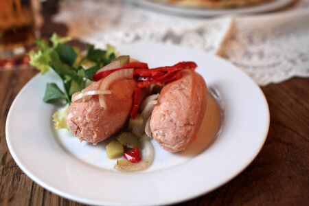 Utopenci are pickled sausages on a plate in the czech restaurant