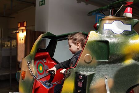 Boy playing on toy helicopter at the playgroundの写真素材