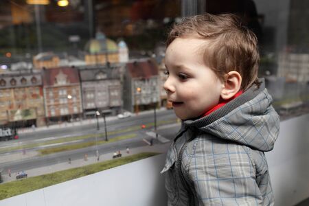 Kid looking at toy city in the indoor playground
