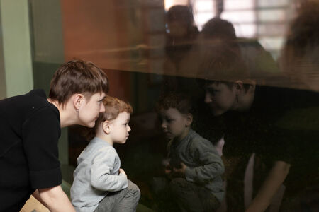 Tourists looking at aquarium in the zooの写真素材