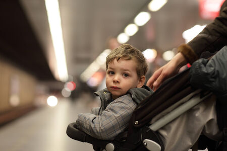 Portrait of serious boy at subway stationの写真素材