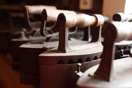 Group of vintage charcoal flatiron in the antique storeの写真素材