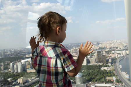 The boy looking at Moscow from penthouse