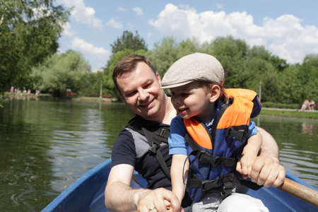 Portrait of father with son in a rowboatの写真素材