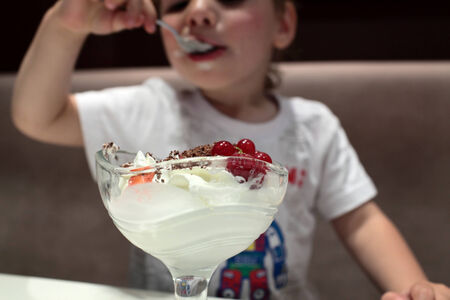 Kid eating ice cream in the cafe