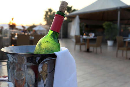 Bottle of red wine in a bucket at the restaurantの写真素材