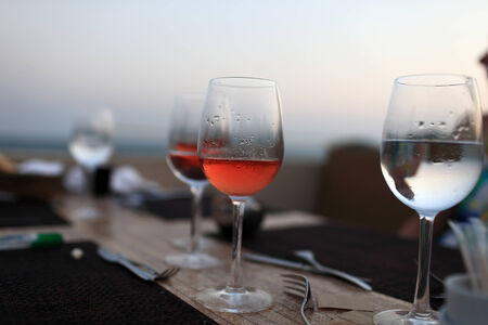 Glasses with drink on the table at a restaurantの写真素材