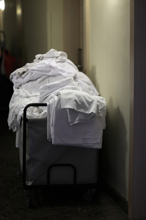 Cleaning cart with bedclothes in the corridor of hotelの写真素材
