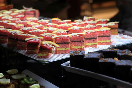 Pieces of cake on a tray at the buffetの写真素材
