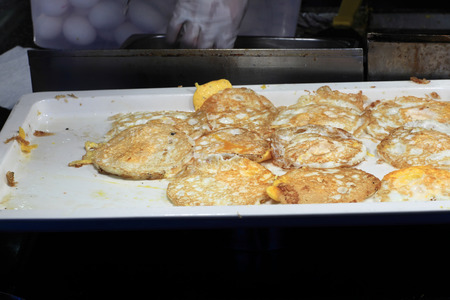 Over easy fried egg on a tray at the buffetの写真素材