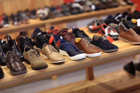 Shoes on the wooden shelf in the storeの写真素材