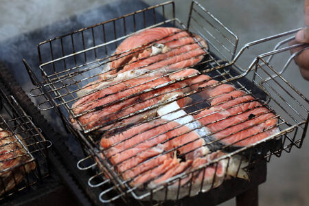 Cooking of salmon steaks on a barbecue grillの写真素材