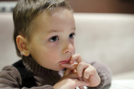 Portrait of pensive child in a cafeの写真素材
