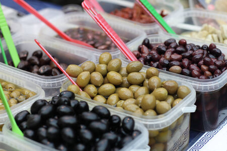 Various olives in the boxes at a marketの写真素材