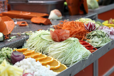 Sliced vegetables on a counter as advertising of a cutterの写真素材