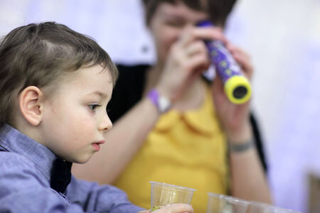 The family making a kaleidoscope at workshop
