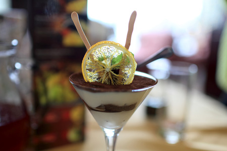 Tiramisu cup on a table in the cafeの写真素材